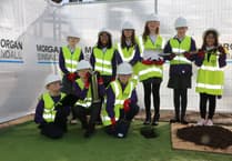 Children bury a time capsule on the new school site in Abergavenny