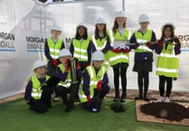 Children bury a time capsule on new 
school site in Abergavenny