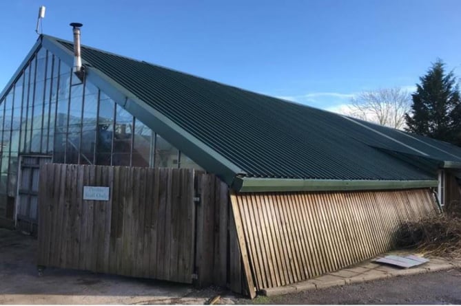 A greenhouse with a tin roof, that is set to be demolished, and currently used as a sales area at Willows Garden Centre in Usk. 