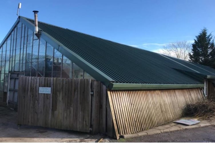 A greenhouse with a tin roof, that is set to be demolished, and currently used as a sales area at Willows Garden Centre in Usk. 