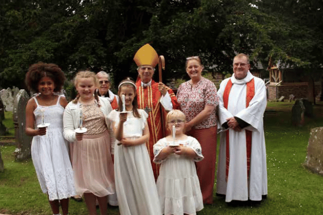 Pictured with the candidates and the clergy is Mrs Helen King, headteacher at Llantilio Pertholey Church in Wales Primary School.