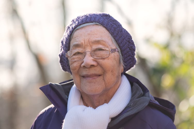 Healthy 92 year old independent Chinese woman taking a winter walk. North Vancouver, British Columbia, Canada.