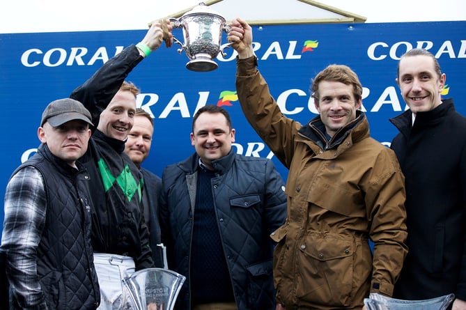 Sam Thomas, in brown coat, celebrates 2022 Welsh National victory