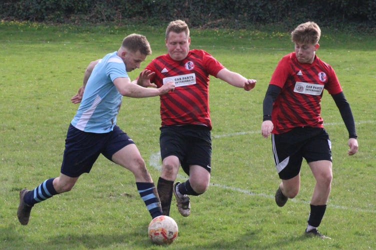 Crickhowell players challenge for the ball