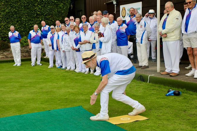 Abergavenny Bowls Club Vice President Martin Love bowling the ceremonial first bowl of the season watched by members