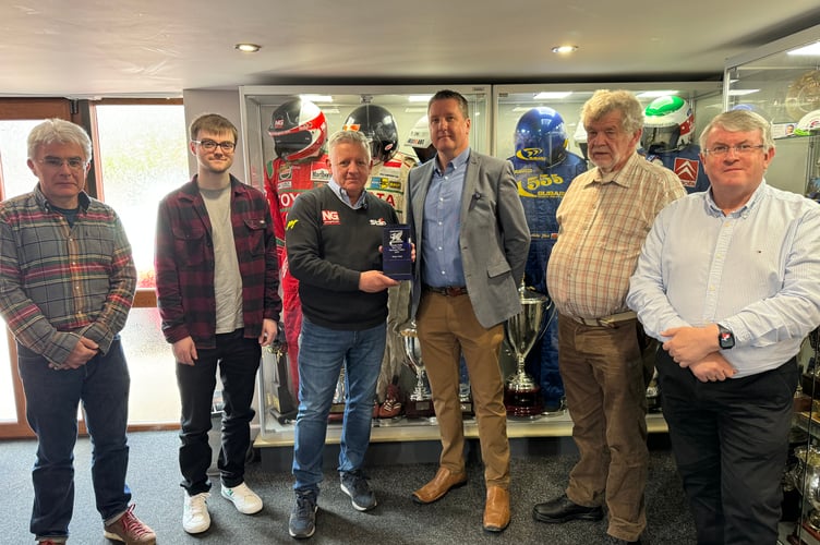 Members of Welsh Motoring Writers assemble to present the Tom Pryce Memorial Trophy to former WRC co-driver Nicky Grist.
