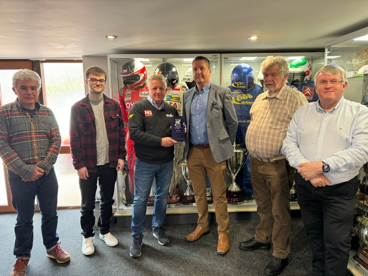 Members of Welsh Motoring Writers assemble to present the Tom Pryce Memorial Trophy to former WRC co-driver Nicky Grist.