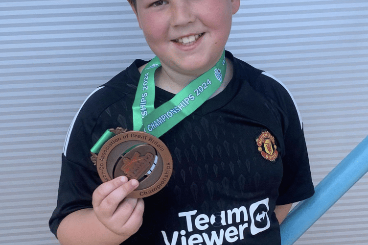 Archie Whittle gets a kick out of winning a medal