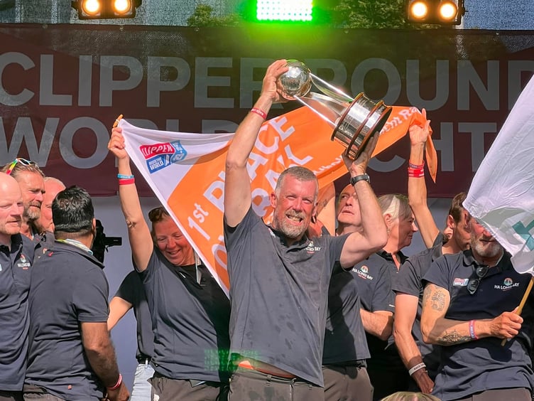 Eric Froggatt lifts the Clipper Round the World trophy