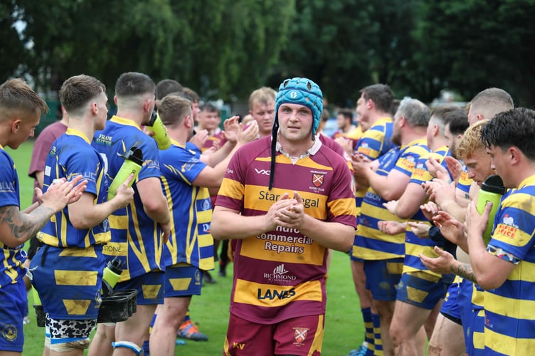 Abergavenny skipper WIll Evans leads off his team after 29-25 victory over Monmouth