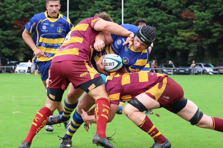 Abergavenny players hold up a Monmouth player