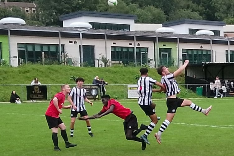 Mark Hughes and Musab Hussein battle for possession