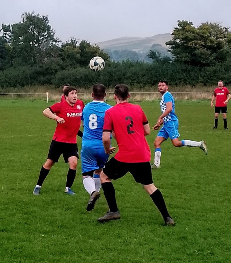 Alex Cavalli heads clear from a Penygarn attacker.