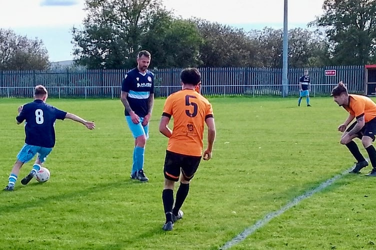Jack Williams on the ball for Mardy supported by Liam Powell