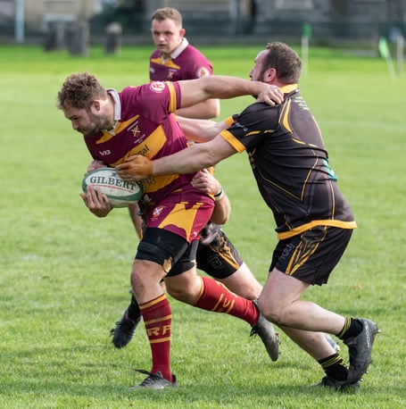 An Aber player tries to charge through