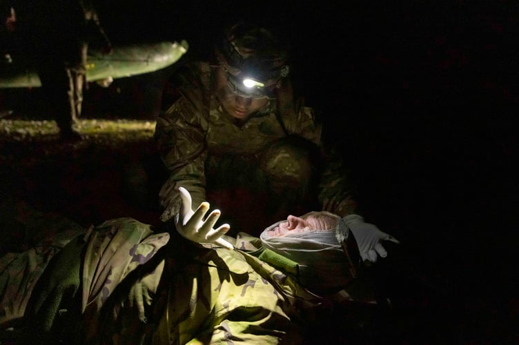 Soldier from 9 Regiment RLC checks his hands for any signs of blood after carrying out the pat test on a simulated casualty during a crashed helicopter scenario on EXERCISE CAMBRIAN PATROL 2024.

Soldiers from across the world are readying themselves for the ultimate challenge of military fieldcraft, navigation, tactics, leadership skills and teamwork.
This all takes place across the undulating terrain of Bannau Brycheiniog (Brecon Beacons) where Exercise Cambrian Patrol has had its roots since 1959.

Around 1,000 troops, spread across eight phases of the event, will be faced with a mock mission that includes covering more than 40 miles from east to west, dealing with enemy threats and various other challenges.

Lieutenant Colonel Will Peltor, Officer Commanding this year's event, said: ÒAs we mark the 65th year since the first Exercise Cambrian Patrol took place itÕs important to note that the event maintains its core standards and is as relevant today, in the modern operational environment, as it was for Territorial Soldiers nearly seven decades ago when they were being tested on their Cold War readiness.