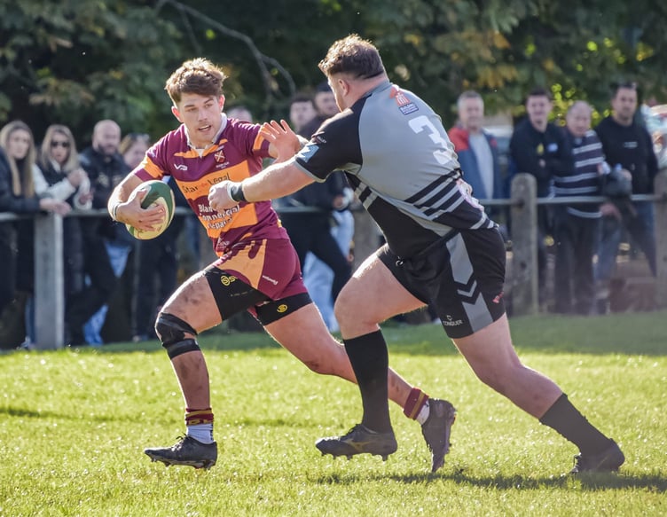 An Abergavenny player bursts through