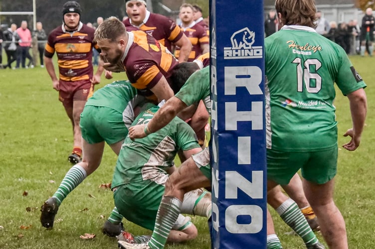 An Abergavenny player forces his way to the line