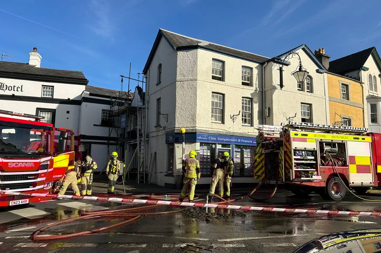 The fire service have closed the A40 through Crickhowell to attend an office fire on the high street. 