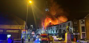 Fire officers speak to residents and business owners following fire