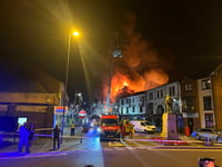 Fire officers speak to residents and business owners following fire