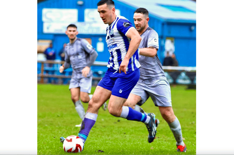 A Blues player shields the ball under pressure from a Bluebird. Photo: Andrew Rees