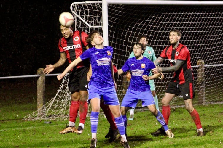 Heads you win! Players challenge for the ball in the Goytre box