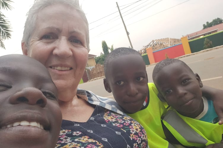 Nessa hands over some Hi Vis Vests to the children to wear as they walk to school each day.