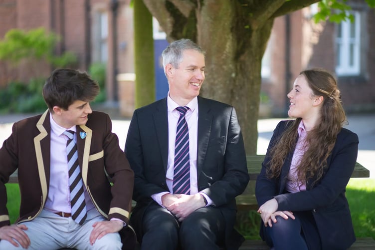 Haberdashers' Monmouth School's executive head Simon Dorman with a former head boy and head girl