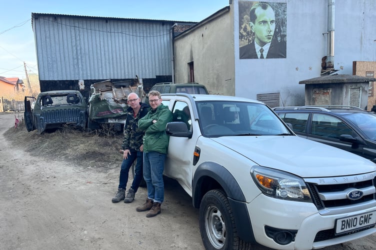 Ashley and James Hawkins with their Ford Ranger upon arriving in Ukraine