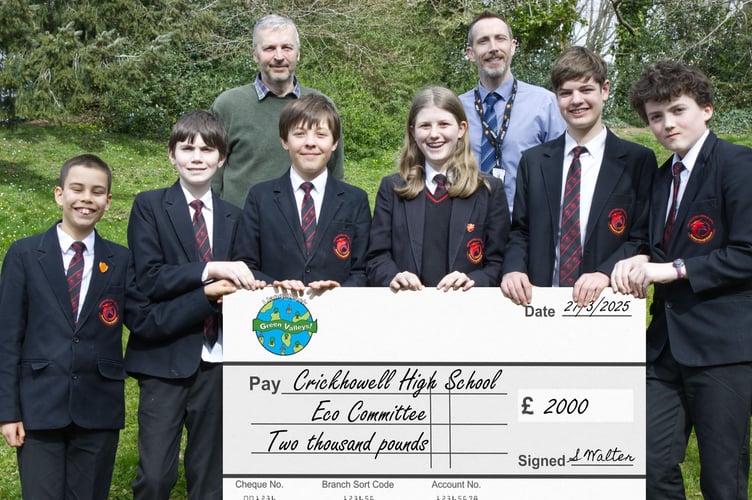 Llangattock Green Valleys Chair Simon Walter presents a cheque for £2,000 to Crickhowell High School’s Mark Jones and members of the School’s Eco Committee