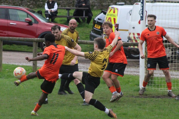 A Monmouth player tries a shot through a crowded Clydach goalmouth