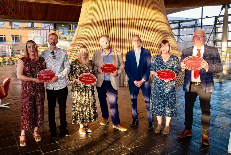 Neil James of Raglan butchers NS James proudly holds the Countryside Alliance Wales 'Butcher of the Year' award alongside other category winners at the Senedd.