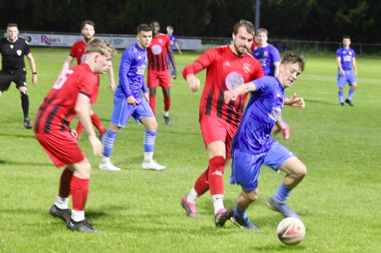 An Abergavenny player escapes the attention of Treharris defenders