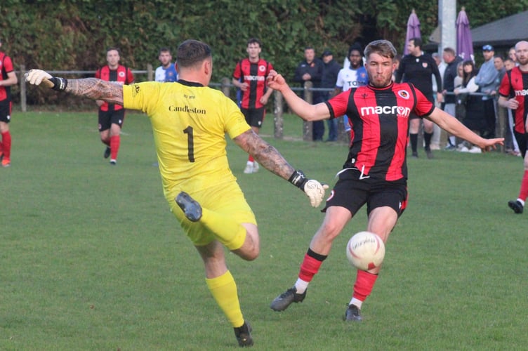 The Chepstow keeper just gets to the ball to clear