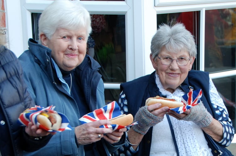 Ann Mason and Janice Davies enjoying their food at the Llangynidr VE Day 80 celebrations 