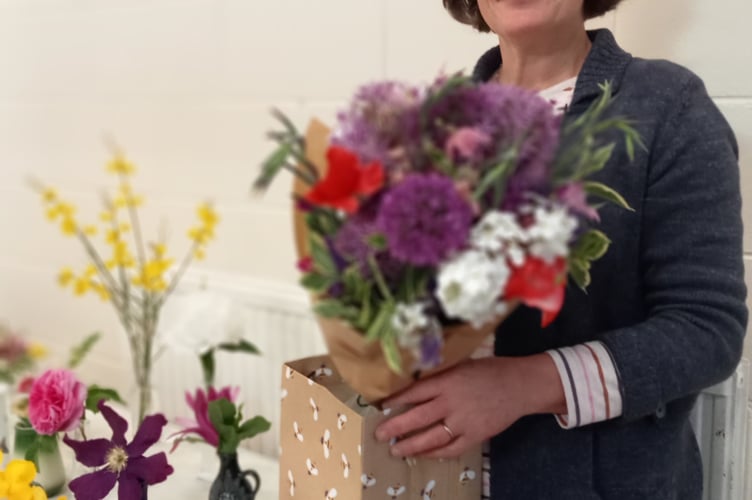 Francesa Philips with some of the Flower of the Month competition entries.