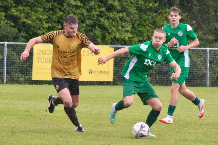 Clydach and Hay players battle for the ball