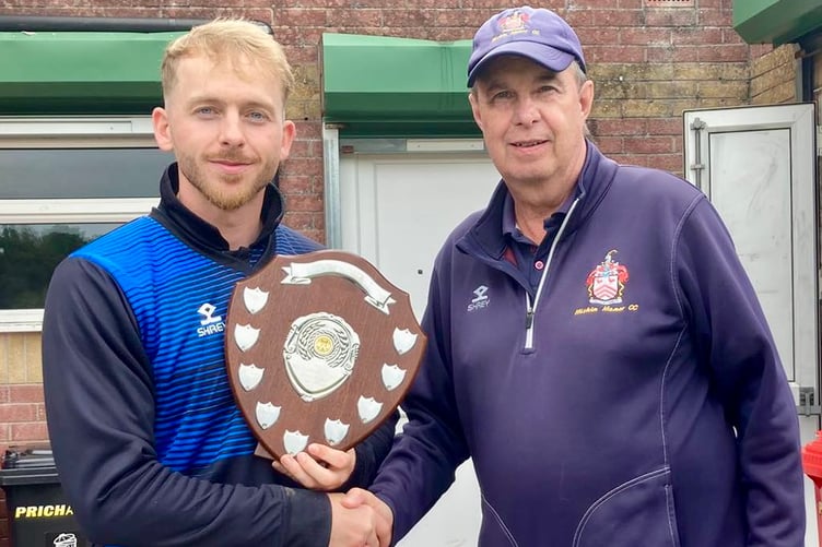 Usk captain Elliott Doyle receiving the trophy from Rob Wilkins of Miskin Manor CC