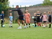 Kids get a big kick out of award-winning summer football camp