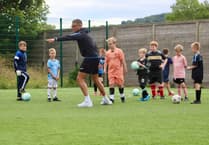 Kids get a big kick out of award-winning summer football camp