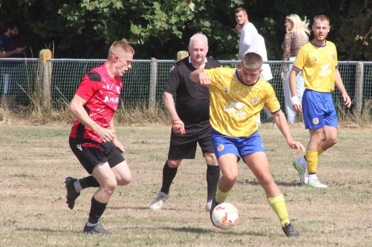 A Mardy player looks to stop a Machen attack