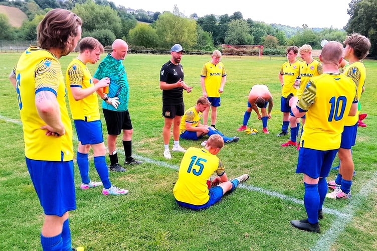 Mardy manager Dai Sadler gives his team a post-match pep talk after Saturday's game.