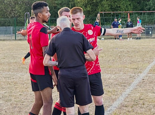 Mardy players discuss an 'offside' decision with the ref