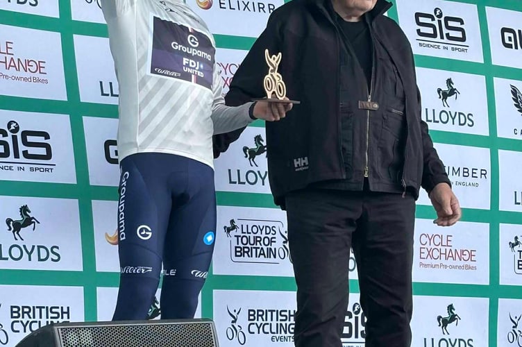 Bill Owen MBE presents Romain Gregoire with the white jersey at the Tour of Britain