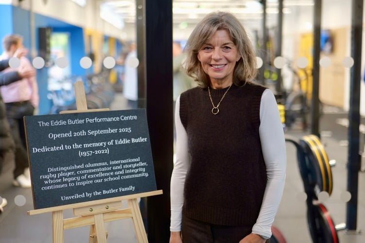 Sue Butler stands beside the plaque dedicated to her husband Eddie at the official opening of the sports centre of excellence named after him at Haberdashers' Monmouth