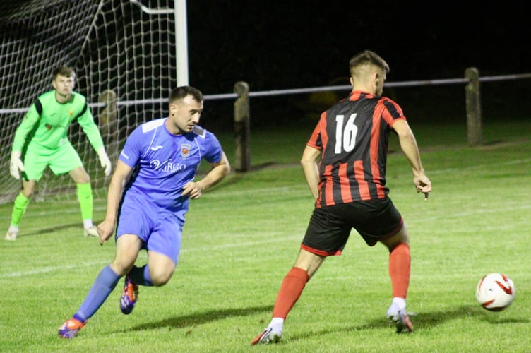 A Goytre player gets a sight of goal