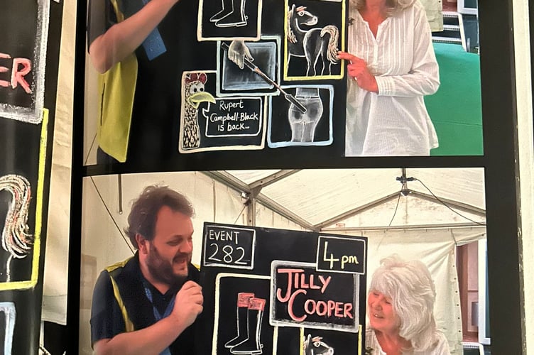 Simon Meredith (left) presents Jilly Cooper with her chalkboard at Hay Festival.