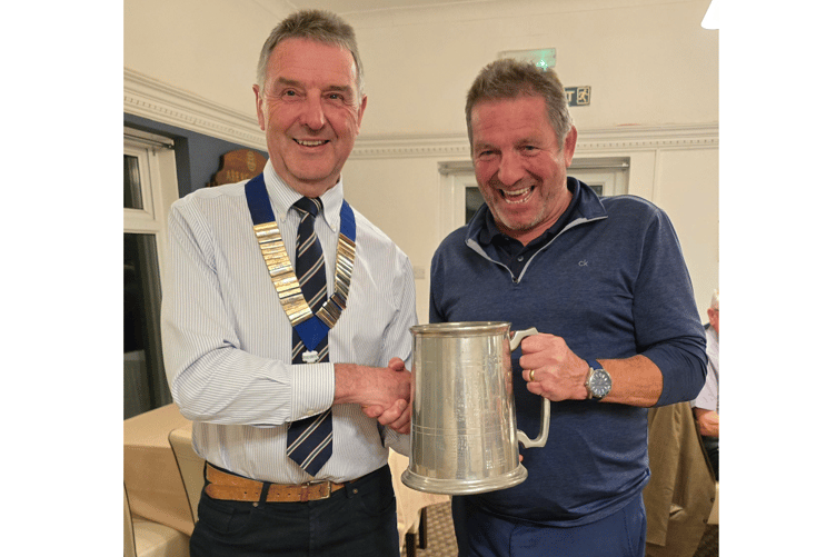Antony Davies presents Golfer of the Day Mark Neil with his trophy
