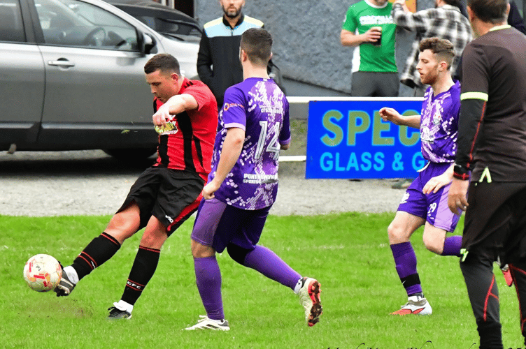 A Crickhowell 2nds player gets a shot away in their 3-0 home win over Pontnewynydd. Photo: Mark Keane Photography